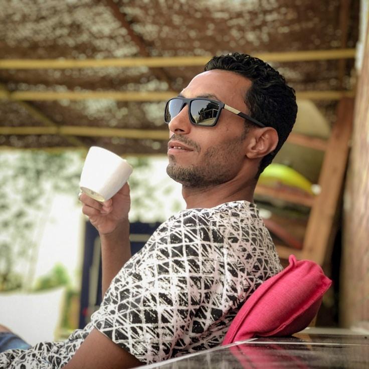 Avery Chen, Lead Design Curator at Bright Stream Center, reviewing corporate floral arrangements